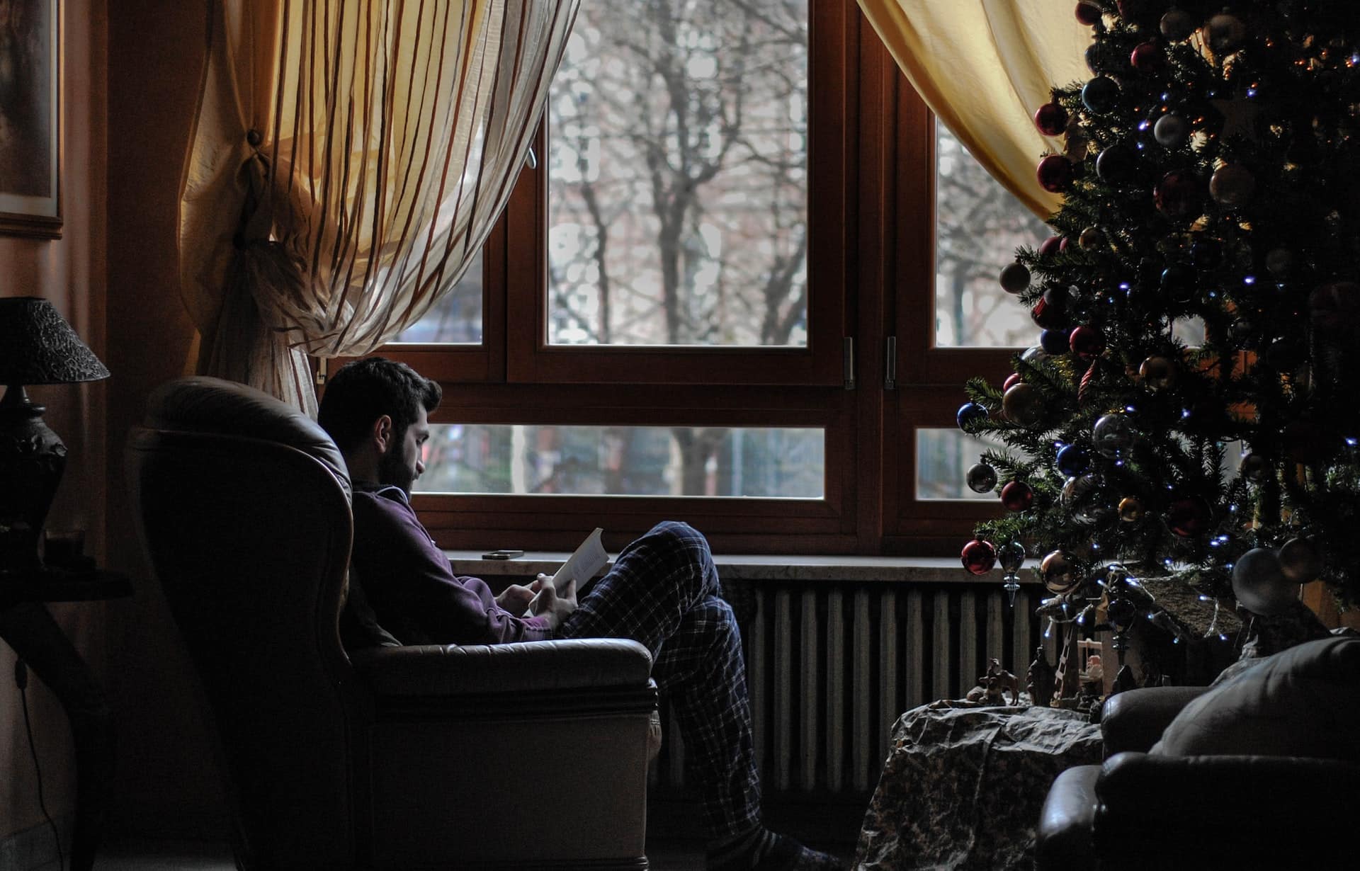 man sitting by the heater at home