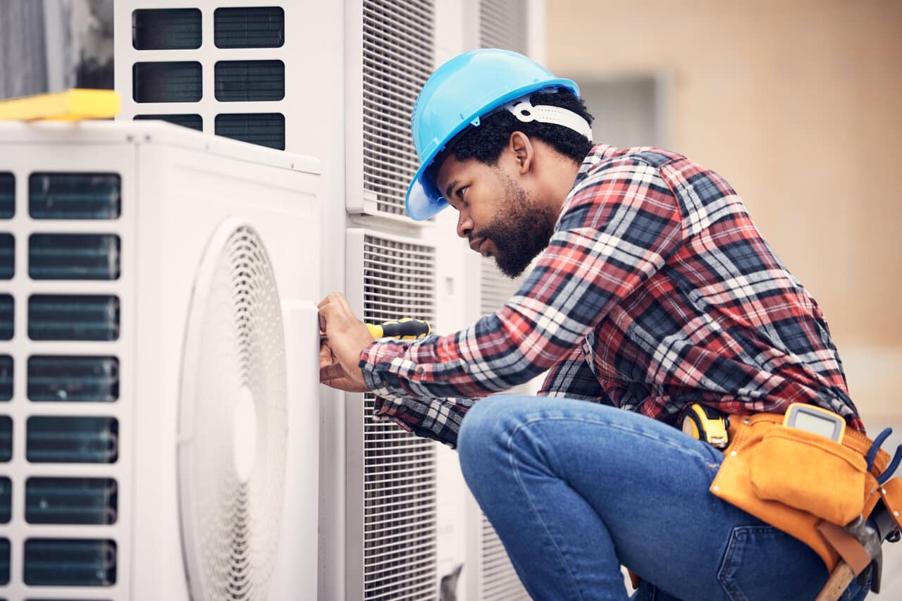 HVAC technician performing inspection in Oshawa