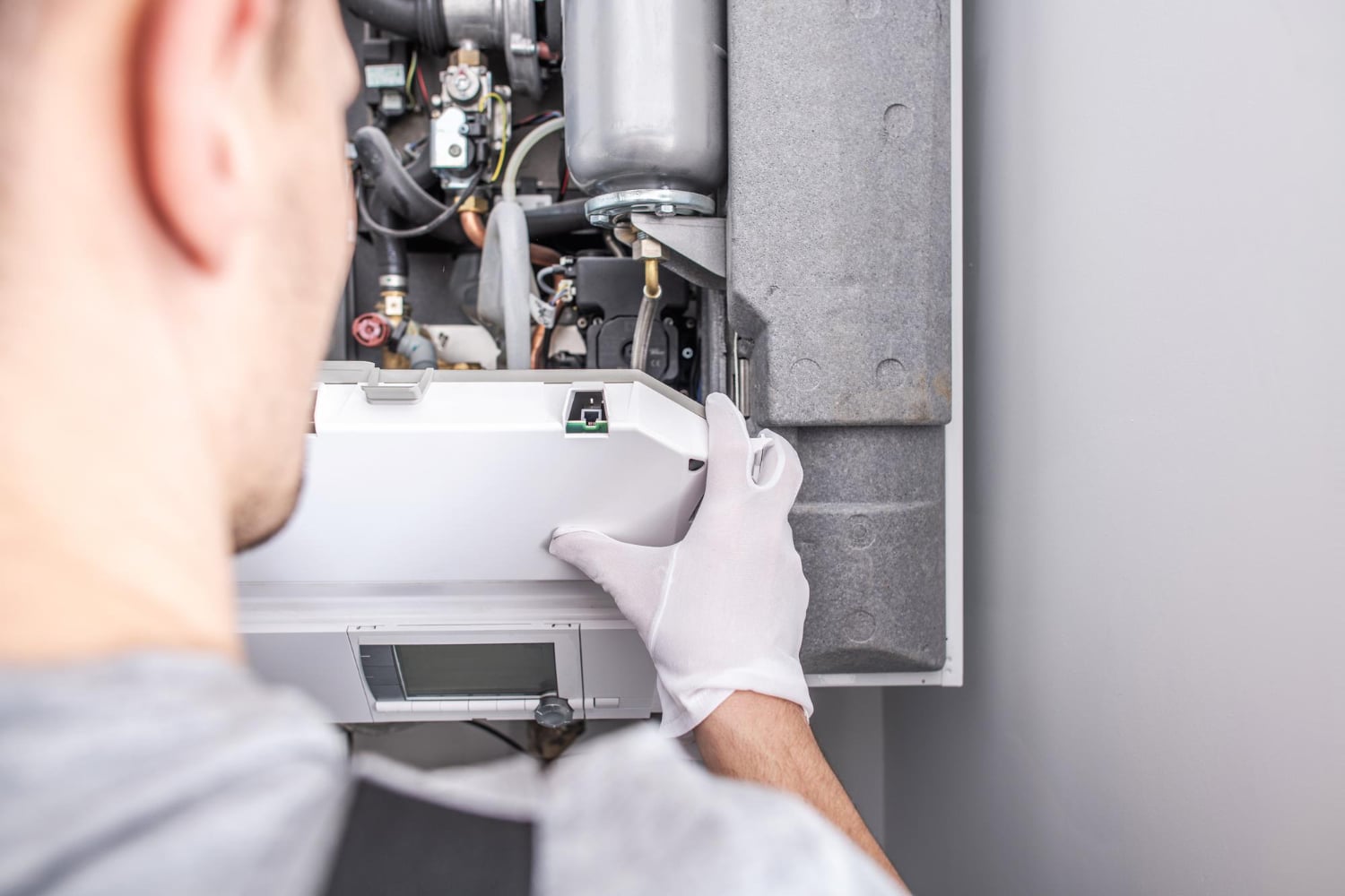 Technician repairing furnace in Durham Region