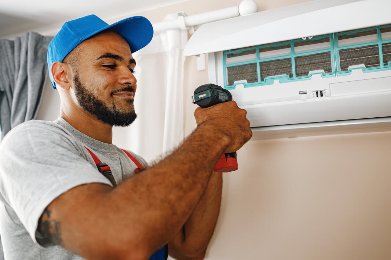 HVAC technician performing spring AC maintenance